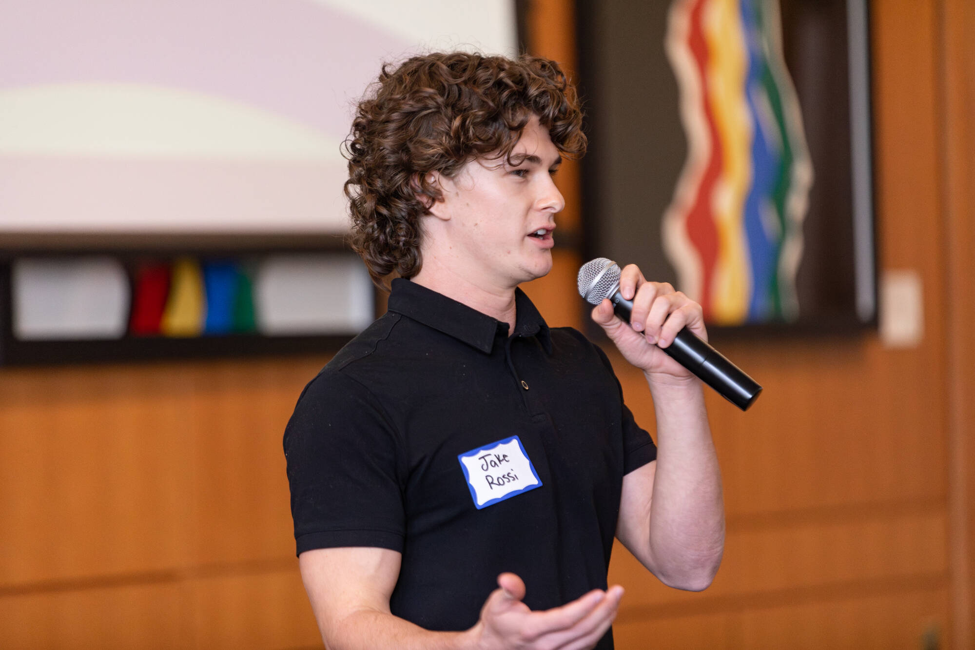 CEO Pitch Competition - Male student speaking into microphone